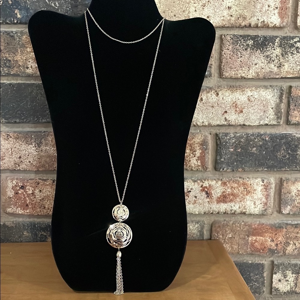 Gold tone double swirl pendant with tassel chain necklace.